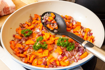 Cut the onions and carrots cooking in a pan