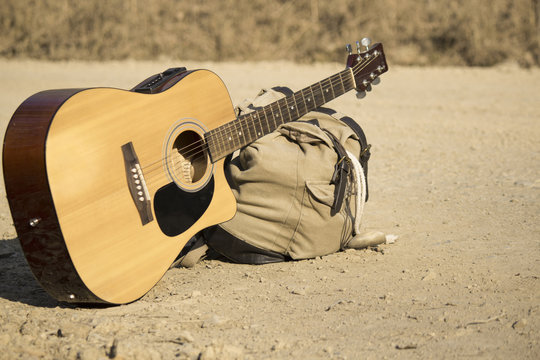 he guitar and backpack lying beside the road