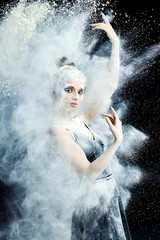 Graceful woman dancing in cloud of dust   © fyb