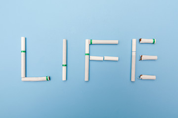 no smoking concept, text made by cigarette on blue backgrounds