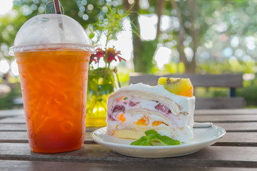 coffee break with fruit cake and tea lemon in garden.