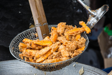 Sweetened fried banana fritters in hot oil, Thailand dessert