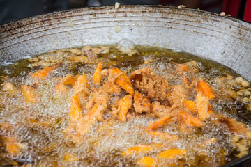 Sweetened fried banana fritters in hot oil, Thailand dessert