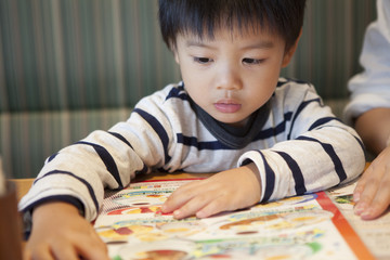 Boy are choosing the menu at the restaurant
