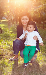Fototapeta premium Asian Granny playing with her grandson in the Park