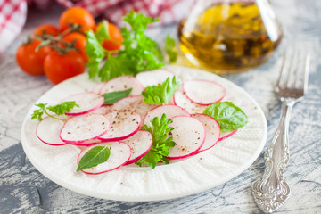 garden radish salad in a plate on a table, selective focus