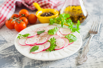 garden radish salad in a plate on a table, selective focus