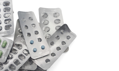 Pile of full and empty pill packages with copy space. Selective focus on blue pills.