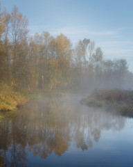 Fototapeta na wymiar Misty morning on the river. Autumn Canada