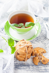 cookies and tea in a cup on a concrete background, selective focus