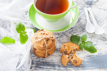 cookies and tea in a cup on a concrete background, selective focus