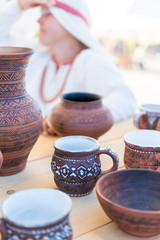 There are many clay pots on the table