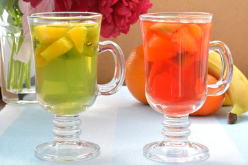 Colorful, red and green jelly with pieces of kiwi, orange, raspberry on foreground