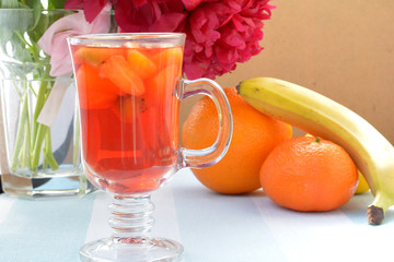 Red martini with pieces of fruits on foreground