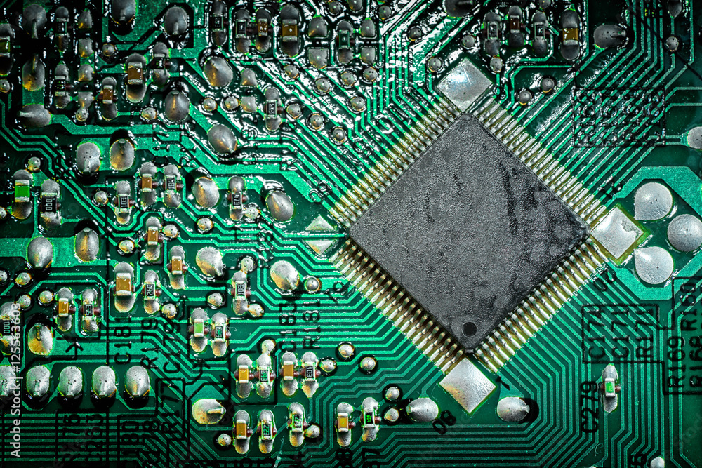 Poster close up of a printed green computer circuit board. electronics and it manufacturing and business ba