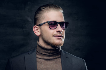 Obraz premium A man in sunglasses in turtle-neck sweate.