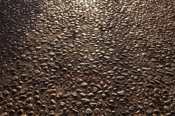 Seamless tile pattern background of small stones on sidewalk or