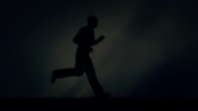 Man Running Fast Under a Storm and Lightning - Loop