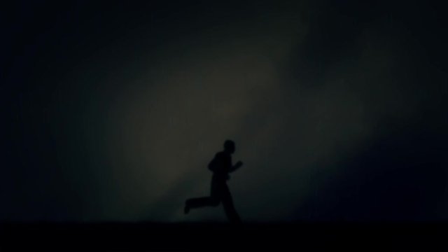 Man Running Fast Under a Lightning Storm and Rain at Night - Loop