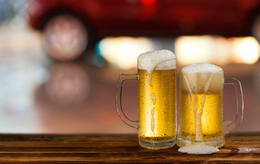 cold mug of beer with foam on the background of the street