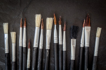 Paint brushes on black background