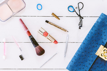 Fototapeta na wymiar Make up bag with cosmetics on wooden background