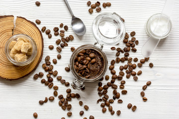 Body scrub of ground coffee top view on wooden table