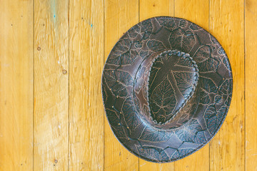 Cowboy hat on wooden background