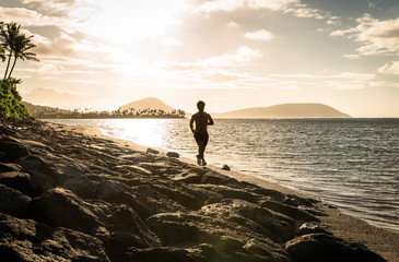 Man running on the beach in Oahu Hawaii