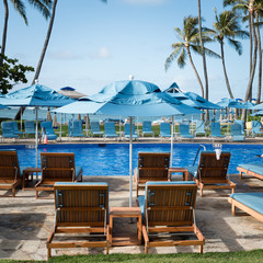 Sunbeds by the pool shining in the morning sun