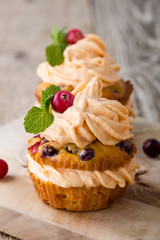 Homemade autumn cranberry pumpkin cupcakes with cream cheese