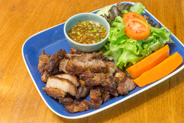 Charcoal-boiled pork neck and spicy sauce with vegetable in dish