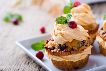 Homemade autumn cranberry pumpkin cupcakes with cream cheese