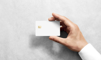 Hand holding blank white credit card mockup with rounded corners. Plain creditcard mock up template...