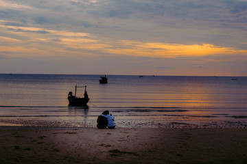 Couple hugging on the beach on sunrise