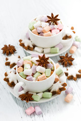 cocoa with colorful marshmallows in cups and Christmas cookies 