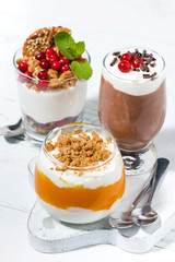 desserts with pumpkin, chocolate and biscuits on white table