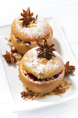 festive baked stuffed apples on white plate, top view