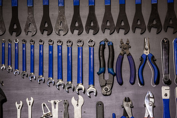 Tools hanging on wall in workshop room.
