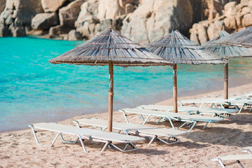 Beach wooden chairs and umbrellas for vacations on beach in Europe