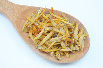 Dry small fish in bowl on white background