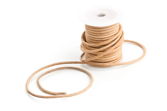 Brown leather cord on plastic spool