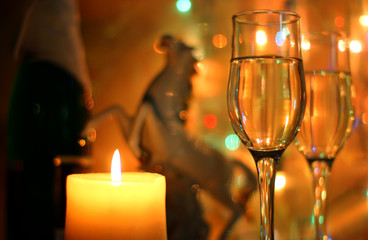 Style New Years Eve celebration background with horse an elegant arrangement with a clock counting down to midnight, flutes and bottle of champagne and party streamers with a candles.