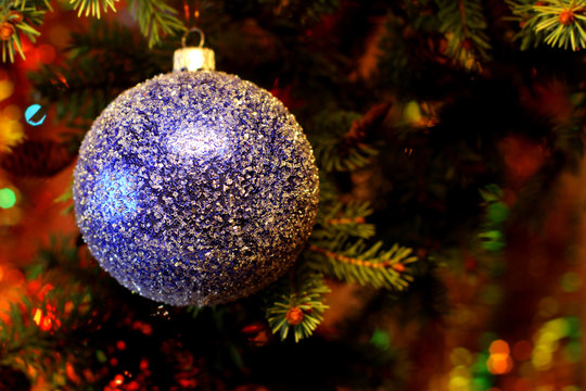 Green color New Years and Christmas Eve celebration background with a Blue ball decoration elegant arrangement clock counting down to midnight, tree brunch. Copyspace. Bokeh light garland backdrops.