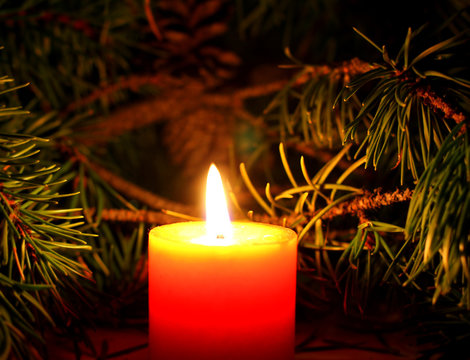 Christmas desktop wallpaper with candles with New Yera`s tree brunch on dark background