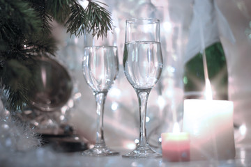 Retro monochrome color style New Years Eve celebration background with an elegant arrangement with a clock counting down to midnight, flutes and bottle of champagne and party garland with a candles.