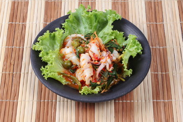 Fried spicy mixed herb  with squid and lettuce.