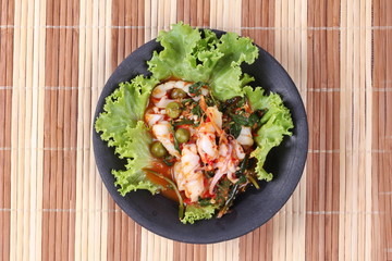 Fried spicy mixed herb  with squid and lettuce.