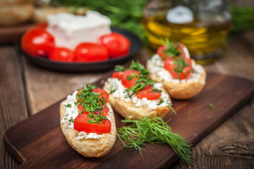 Delicious bruschetta with tomatoes, feta cheese, dill and spice