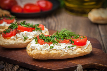 Delicious bruschetta with tomatoes, feta cheese, dill and spice